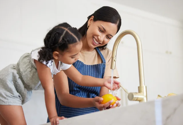 Mother and child preparing food with filtered water